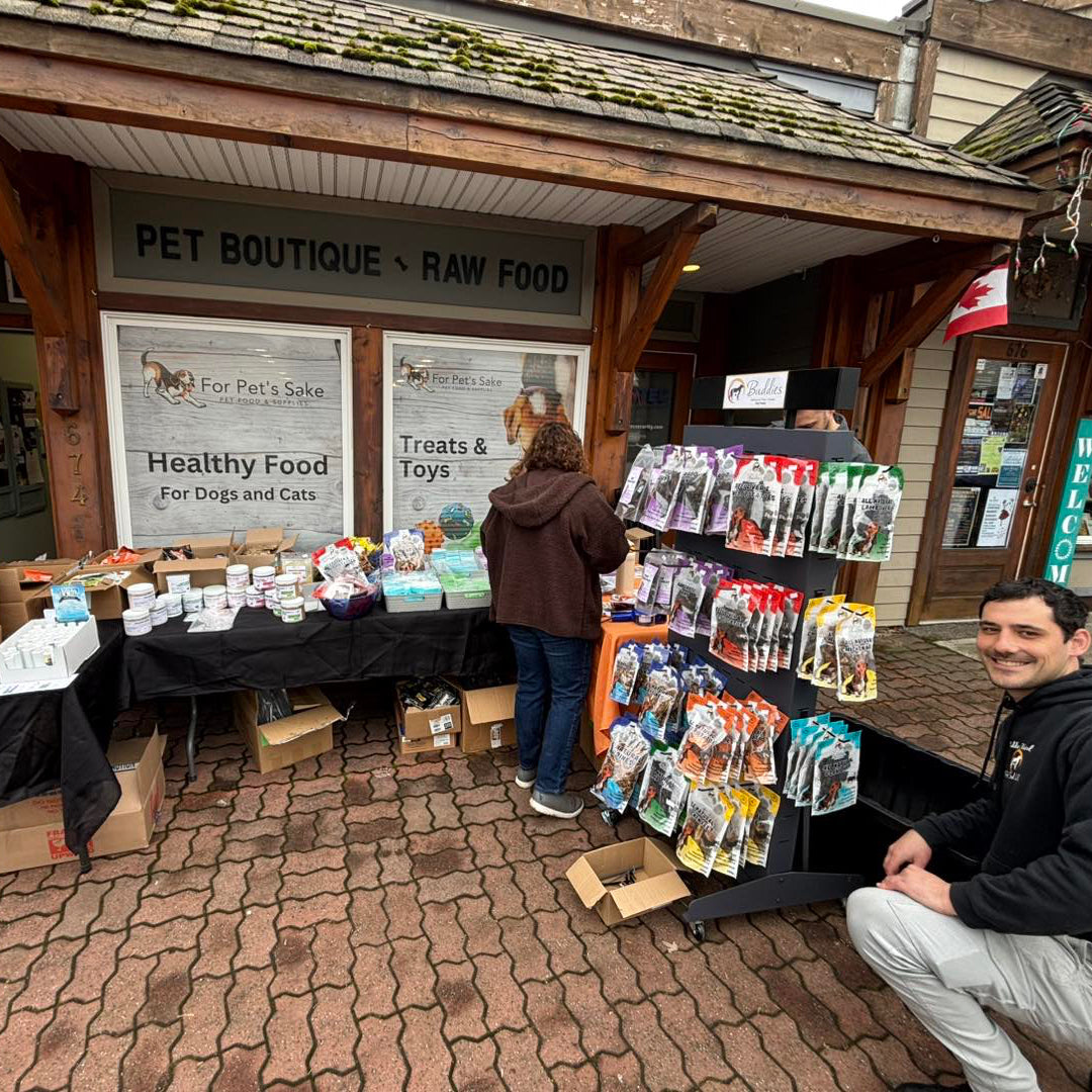 Pet boutique with raw food and healthy food products displayed outside a building.